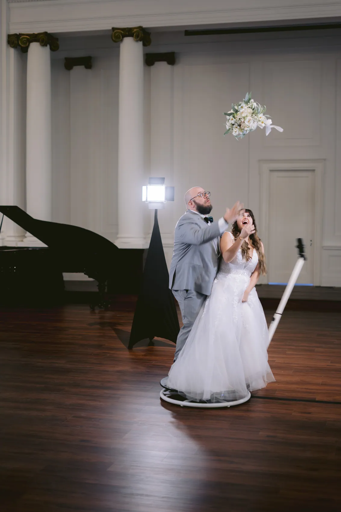 A couple on the 360 platform mid spin as the camera arm swings past