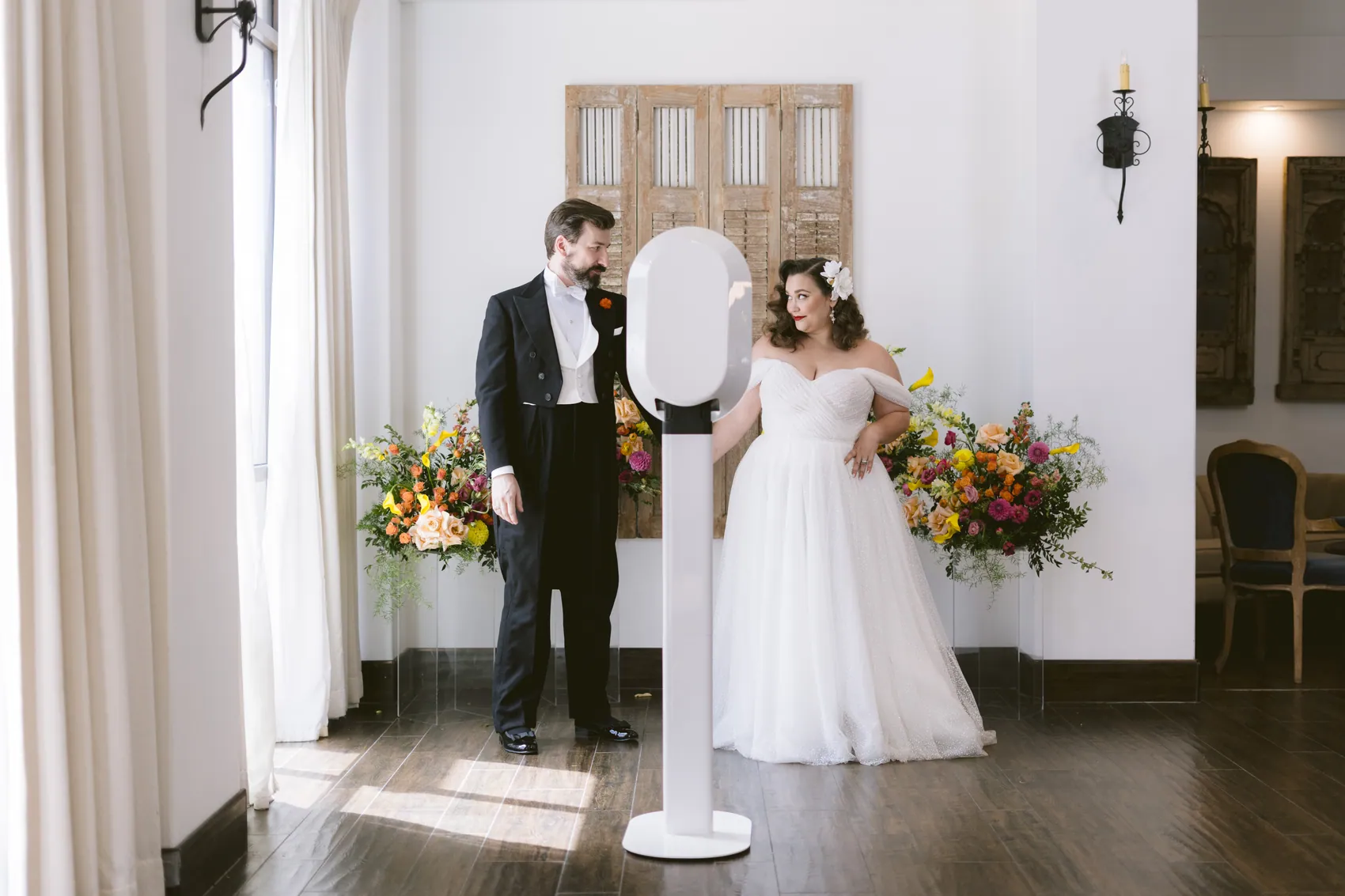 A couple either side of the booth in a sunlit room